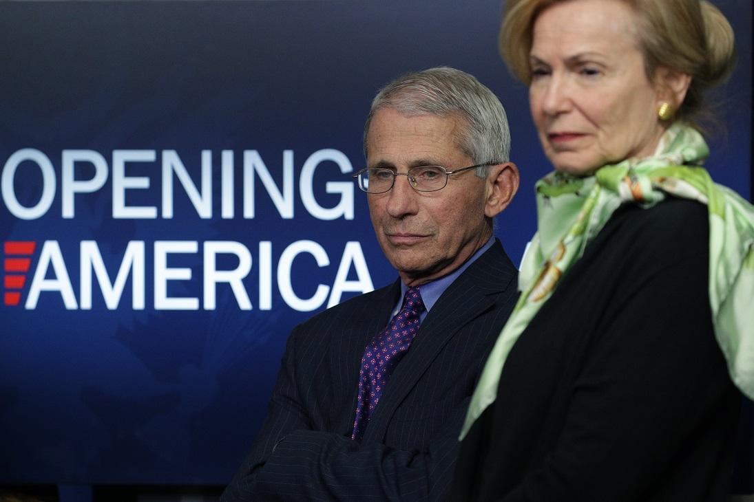 Dr. Anthony Fauci, director of the National Institute of Allergy and Infectious Diseases, and Deborah Brix, White House coronavirus response coordinator, listen to President Donald Trump speak at the daily briefing of the CCP virus task force at the White House in Washington on April 16, 2020. (Alex Wong/Getty Images)