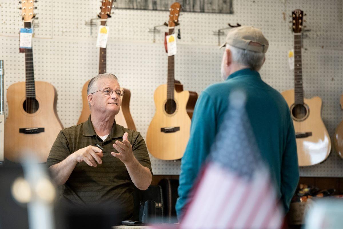 Small business owner Willie Wells (L) talks with Master guitar-maker Larry Threet at Bills Pickin' Parlor in West Columbia, South Carolina, on April 23, 2020. (Sean Rayford/Getty Images)