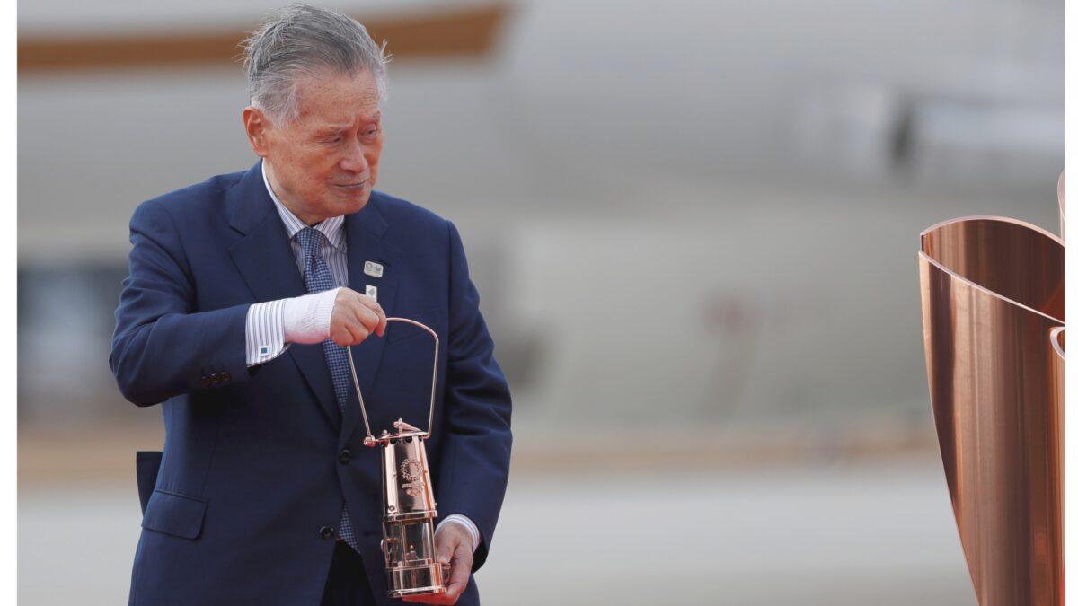 Tokyo 2020 Olympics President Yoshiro Mori holds the Olympic Flame during a ceremony at Japan Air Self-Defense Force Matsushima Base in Higashi-Matsushima, Japan, on March 20, 2020. (Issei Kato/Reuters)
