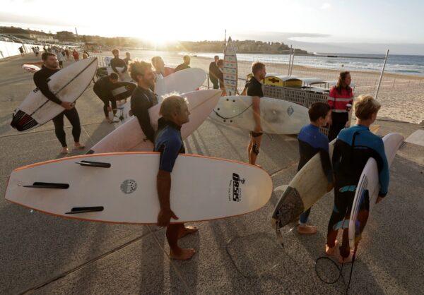 As CCP virus pandemic restrictions are eased, surfers wait for officials to open Bondi Beach in Sydney, on April 28, 2020. (Rick Rycroft/AP Photo)
