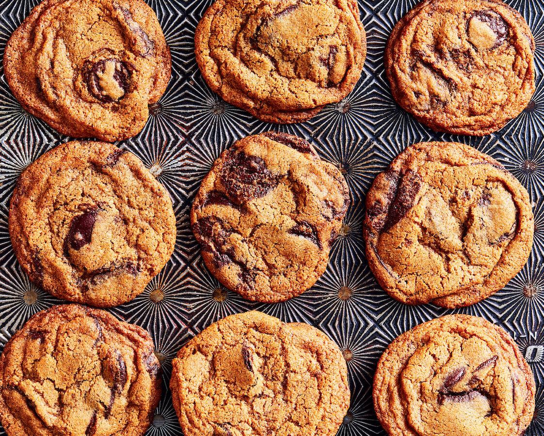 A soft-centered, caramelized-edged chocolate chip cookie, still warm and dappled with dark chocolate puddles, is instant comfort. (Julia Gartland)