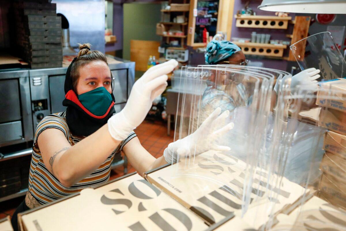 Tara Kline makes acrylic face shields for front line responders at Dimo's Pizza in Chicago, Illinois, on April 16, 2020. (Kamil Krzaczynski/AFP via Getty Images)
