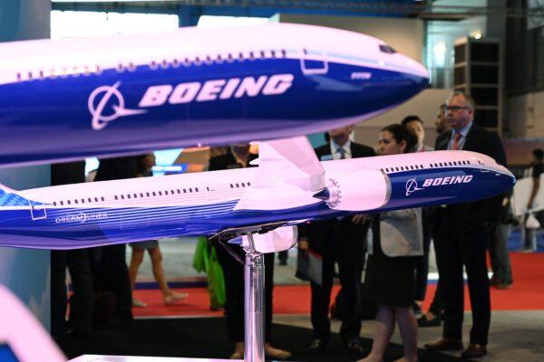 Visitors look at Boeing 787 and 777 model displays at the Singapore Airshow in Singapore on Feb. 12, 2020. (Roslan Rahman/AFP/Getty Images)