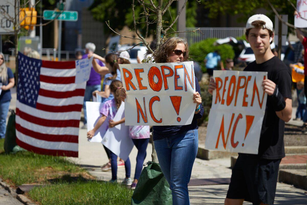 Protesters from a grassroots organization called ReOpen NC demonstrate against the North Carolina coronavirus lockdown at a parking lot adjacent to the North Carolina State Legislature in Raleigh, North Carolina, on April 14, 2020. (Logan Cyrus/AFP/Getty Images)