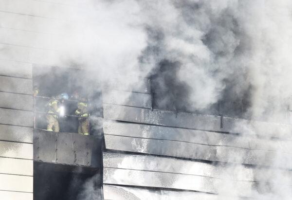 Firefighters search for survivors as smoke rises from a warehouse which is currently under construction, after it caught fire, in Icheon, South Korea, on April 29, 2020. (Yonhap via Reuters)