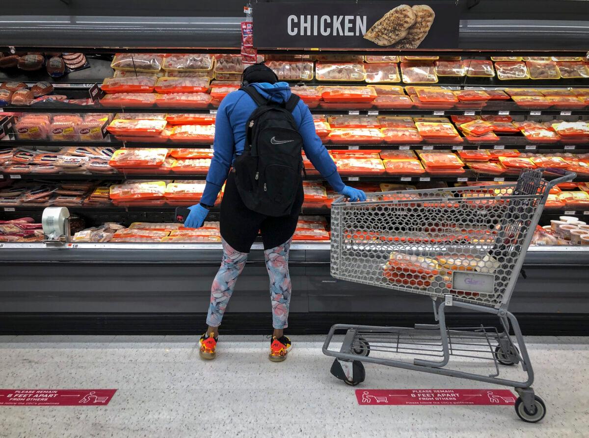 A woman shops in the chicken and meat section at a grocery store in Washington on April 28, 2020. (Drew Angerer/Getty Images)