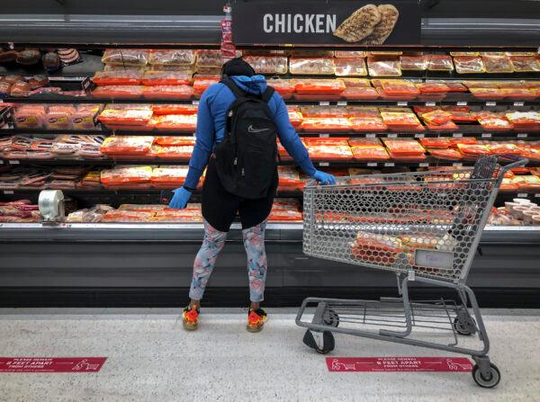 A woman shops in the chicken and meat section at a grocery store in Washington, on April 28, 2020. (Drew Angerer/Getty Images)