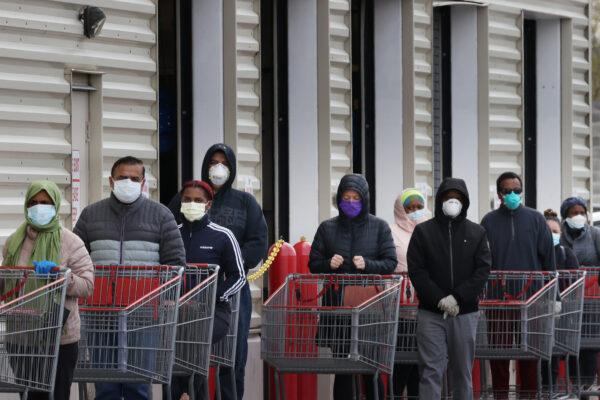 Customers wear masks to prevent the spread of the CCP virus as they line up to enter a Costco in Wheaton, Maryland, on April 16, 2020. (Chip Somodevilla/Getty Images)
