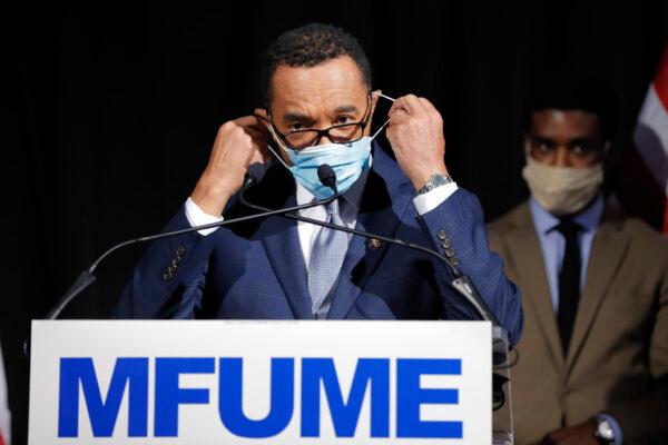 Democrat Kweisi Mfume removes a face mask before addressing reporters during an election night news conference after he won the 7th Congressional District special election, Tuesday, April 28, 2020, in Baltimore. (Julio Cortez/AP Photo)