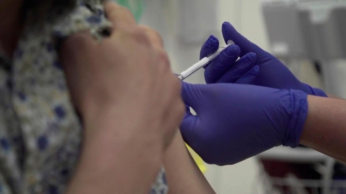 Screen grab taken from video issued by Britain's Oxford University, showing a person being injected as part of the first human trials in the UK to test a potential COVID-19 vaccine, taken by Oxford University, England on April 23, 2020. (Oxford University Pool via AP)