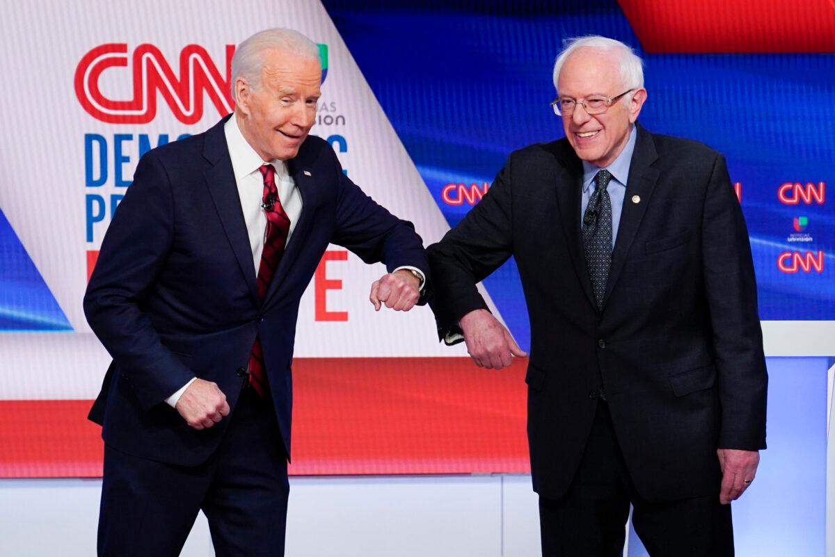 Former Vice President Joe Biden (L) and Sen. Bernie Sanders (R) greet each other before they participate in a Democratic presidential primary debate at CNN Studios in Washington, on March 15, 2020. (Evan Vucci/AP Photo)