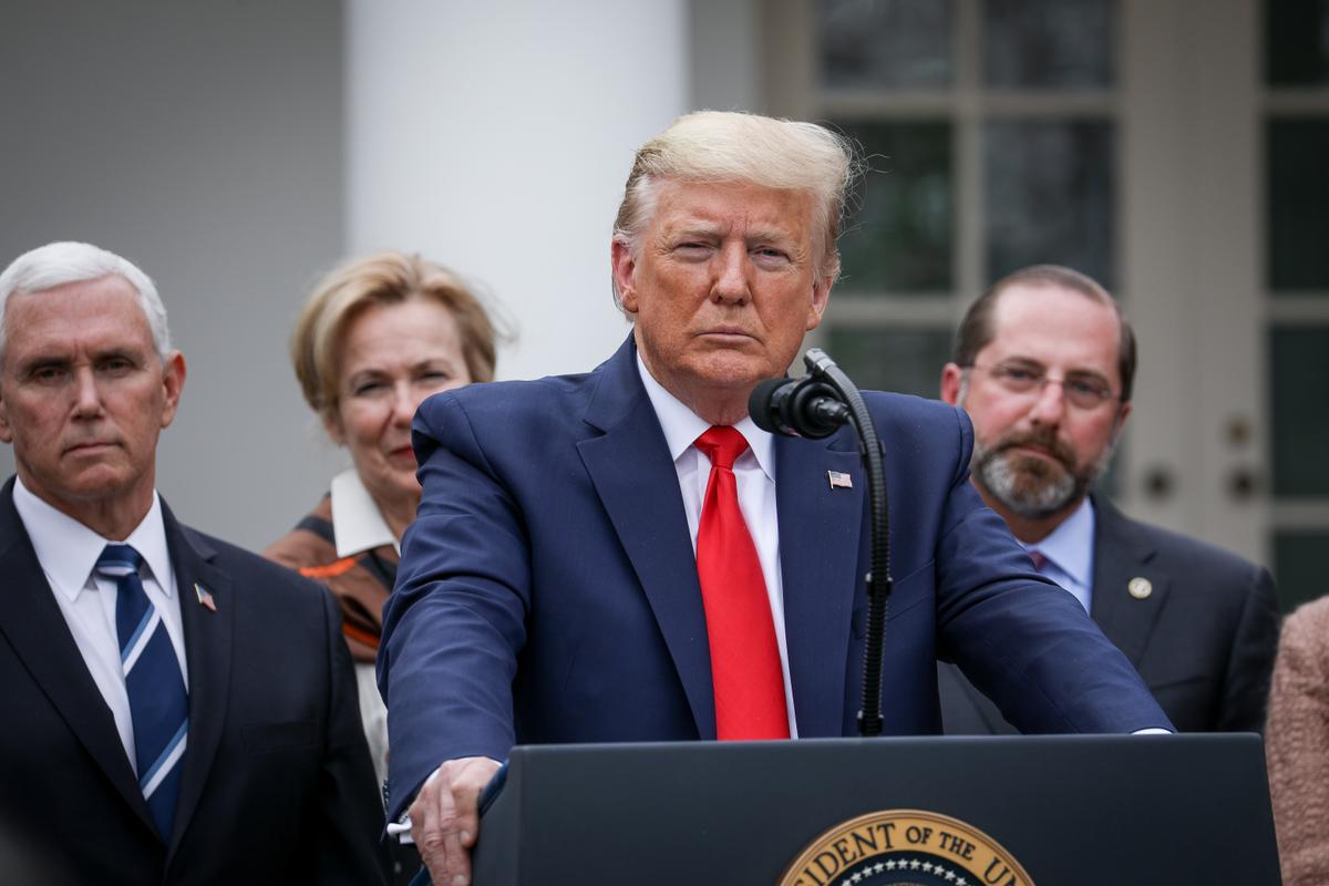 President Donald Trump, flanked by officials and business leaders, announces a national emergency with regard to the coronavirus in the White House Rose Garden in Washington on March 13, 2020. (Charlotte Cuthbertson/The Epoch Times)
