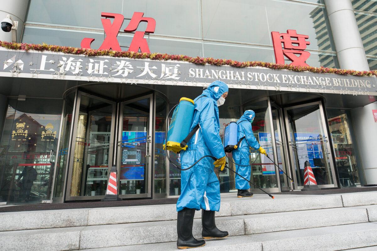 Medical workers spray antiseptic outside the main gate of the Shanghai Stock Exchange Building in Shanghai, China, on Feb. 3, 2020. (Yifan Ding/Getty Images)