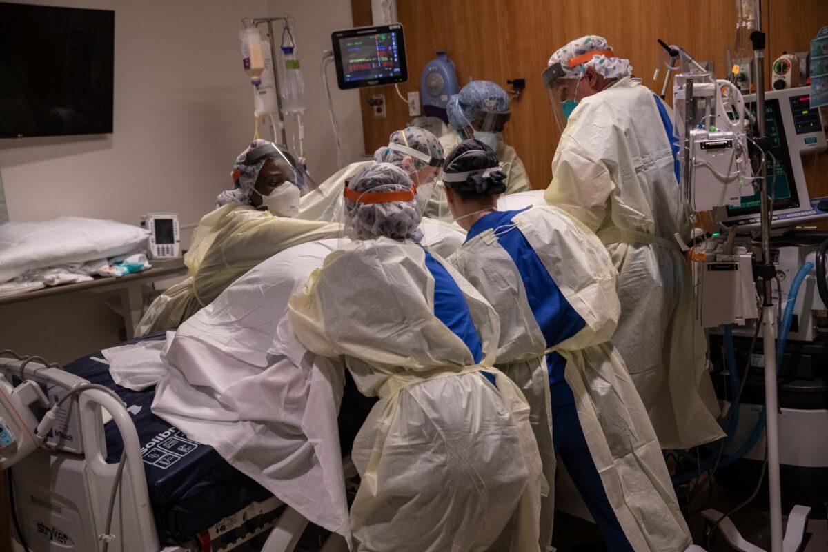 A "prone team," wearing personal protective equipment turns a COVID-19 patient onto his stomach in a Stamford Hospital intensive care unit, in Stamford, Ct., on April 24, 2020. (John Moore/Getty Images)
