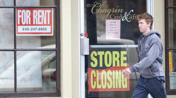 A man walks past a closed business in Chagrin Falls, Ohio, on April 29, 2020. (Tony Dejak/AP Photo)