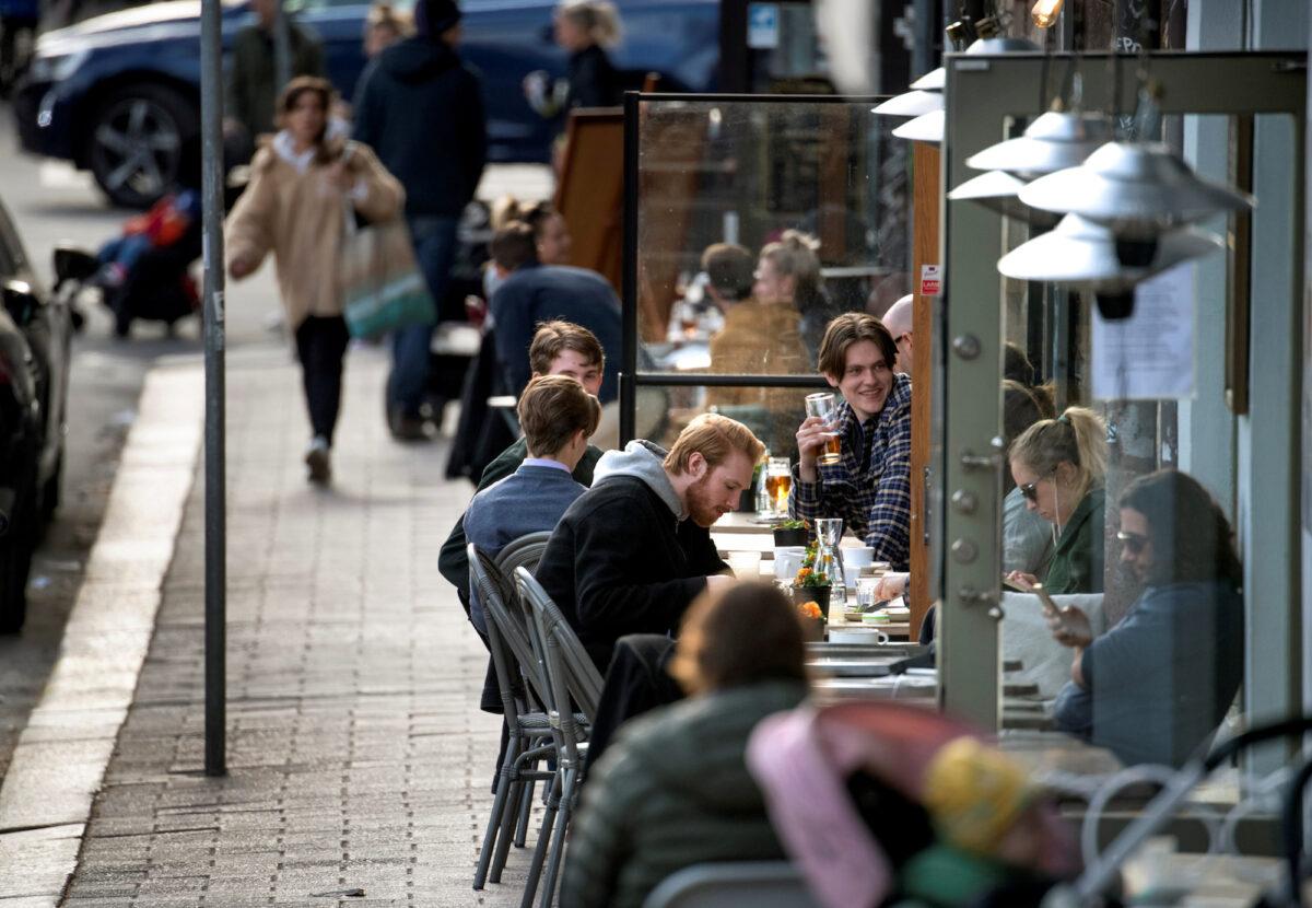 People enjoy themselves at an outdoor restaurant in Stockholm, Sweden, on April 20, 2020. (Anders Wiklund/TT News Agency/Reuters)