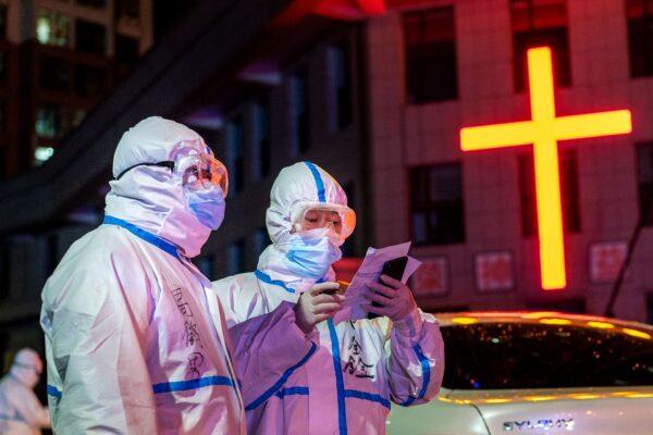 Medical workers are looking for close contacts with patients that tested positive on nucleic acid tests in Suifenhe, China, on April 25, 2020. (STR/AFP via Getty Images)