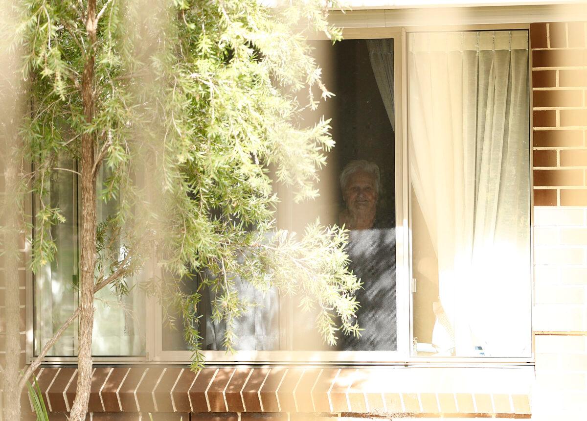 Newmarch House resident Patricia Shea looks at her son out of her window through the fence at Newmarch House on April 29 in Sydney, Australia. (Ryan Pierse/Getty Images)