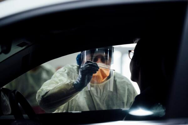 Nurses test a patient at the ACT's drive-through COVID-19 testing site in Canberra, Australia on May 1, 2020. (Rohan Thomson/Getty Images)