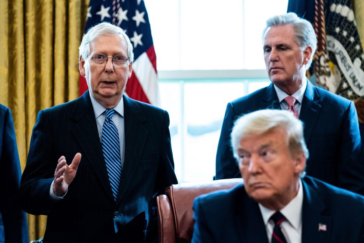 Senate Majority Leader Mitch McConnell (R-Ky.) speaks as House Minority Leader Kevin McCarthy (R-Calif.) and President Donald Trump listen during a signing ceremony for H.R. 748, the CARES Act in the Oval Office of the White House in Washington on March 27, 2020. (Erin Schaff-Pool/Getty Images)