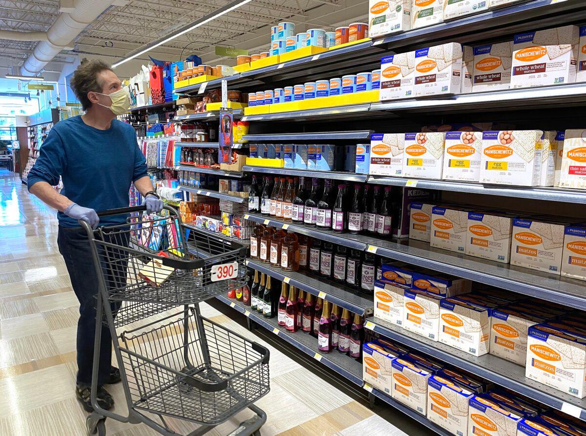 A man wearing a mask shops for Passover items at a grocery store during the COVID-19 pandemic in Overland Park, Kansas, on April 7, 2020. (Jamie Squire/Getty Images)