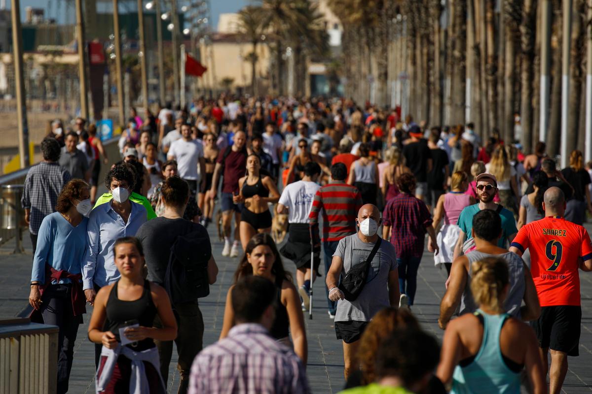 People exercise on a seafront promenade in this photo taken with a telephoto lens in Barcelona, Spain, Saturday, May 2, 2020. (Emilio Morenatti/AP Photo)