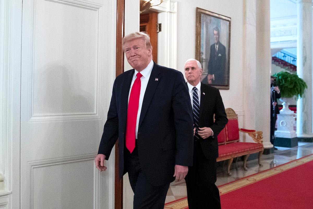 President Donald Trump, followed by Vice President Mike Pence, arrives to speak about reopening the country, during a roundtable with industry executives in the State Dining Room of the White House in Washington on April 29, 2020. (Alex Brandon/AP Photo)