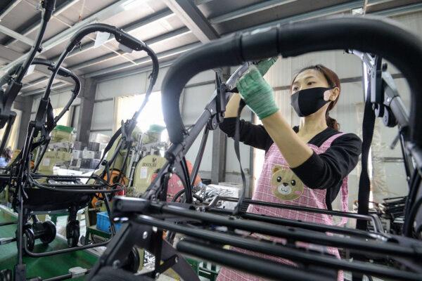 A worker produces baby carriages at a factory in Handan in China's northern Hebei Province on April 29, 2020. (STR/AFP via Getty Images)