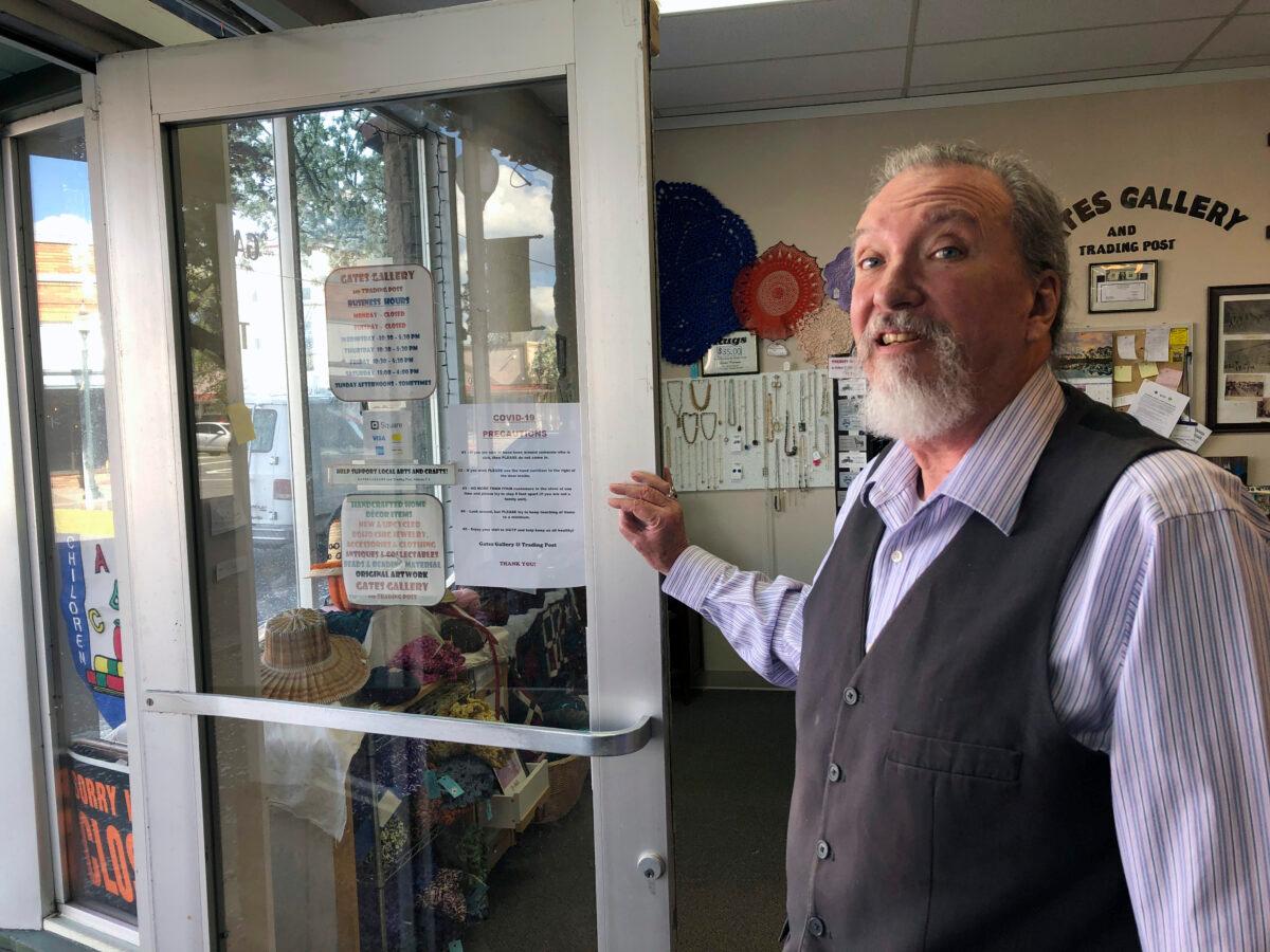 Gerry Gates, owner of Gates Gallery and Trading Post on Main Street stands at the front door of his shop in Alturas, Calif. on May 1, 2020. Gates' gallery opened Friday for the first time in seven weeks. (Scott Sonner/AP Photo)