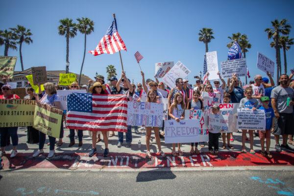 Protesters gather in a demonstration in Huntington Beach, Calif., on May 1, 2020. (Apu Gomes/Getty Images)