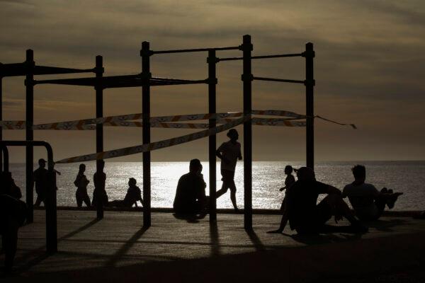 On May 2, 2020, for the first time after seven weeks of confinement in their homes to fight the CCP virus pandemic, people exercises in a seafront promenade in Barcelona, Spain. (Emilio Morenatti/AP photo)
