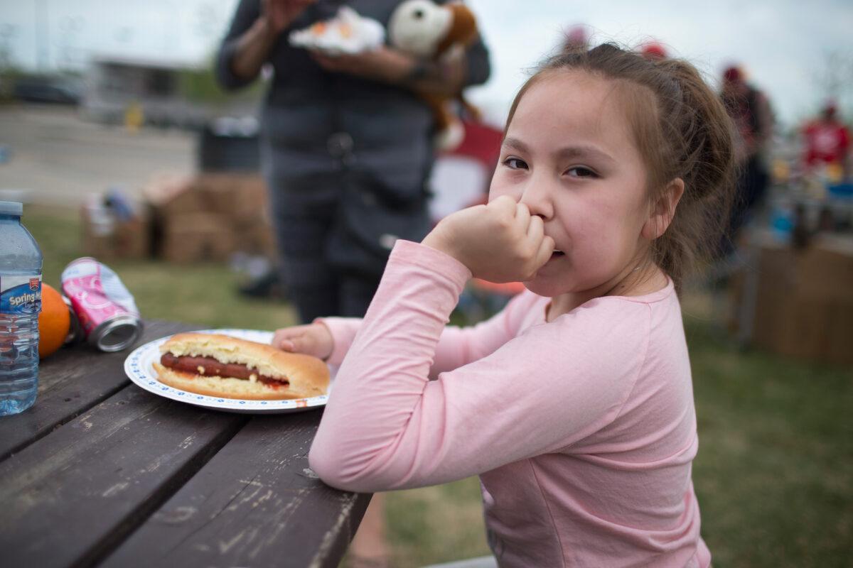 Malibu Chartrand eats dinner at an evacuation center on May 7, 2016 in Lac La Biche, Alberta. Wildfires, which are still burning out of control, have forced the evacuation of more than 80,000 residents from Fort McMurray and surrounding areas. (Scott Olson/Getty Images)
