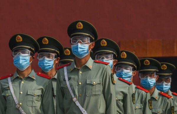 Chinese paramilitary police wear protective masks as they guard the entrance to the Forbidden City in Beijing on May 2, 2020. (Kevin Frayer/Getty Images)