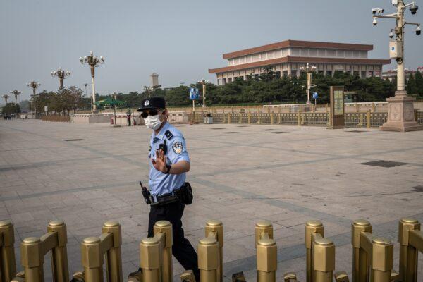 A police officer gestures as he secures an area outside Beijing's Tiananmen Square, on World Press Freedom Day in Beijing, China, on May 3, 2020. (Nicolas AsfouriI/AFP via Getty Images)