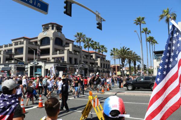 Protesters march down Main Street in Huntington Beach, Calif., on May 1, 2020. (Jamie Joseph/The Epoch Times)