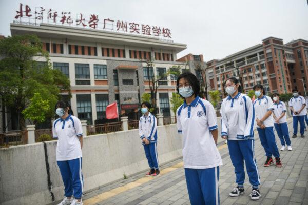 Students are queueing to receive nucleic acid testing for the CCP virus at a middle school in Guangzhou, China on April 21, 2020. (STR/AFP via Getty Images)
