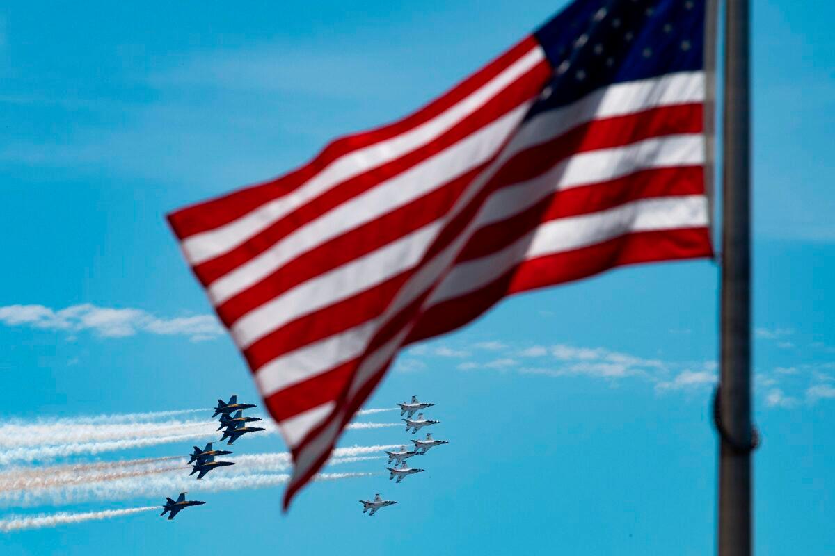 The U.S. Navy Blue Angels (L) and U.S. Air Force Thunderbirds fly over the National Mall in Washington, on May 2, 2020, in a tribute to essential workers during the coronavirus pandemic. (Jim Watson/AFP via Getty Images)