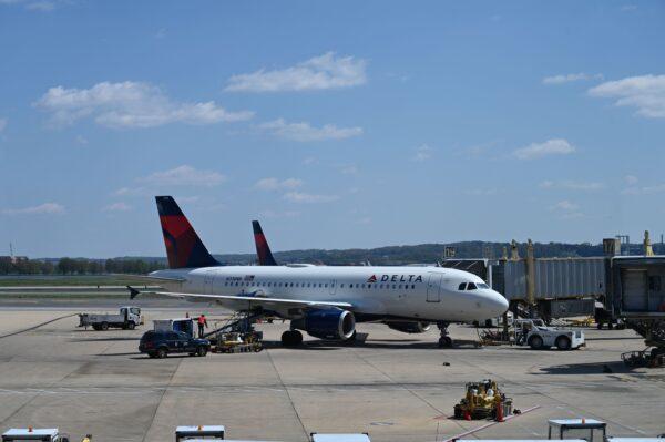 A Delta Airlines airplane is seen at gate at Washington National Airport (DCA) in Arlington, Va. on April 11, 2020. (Daniel Slim/AFP via Getty Images)