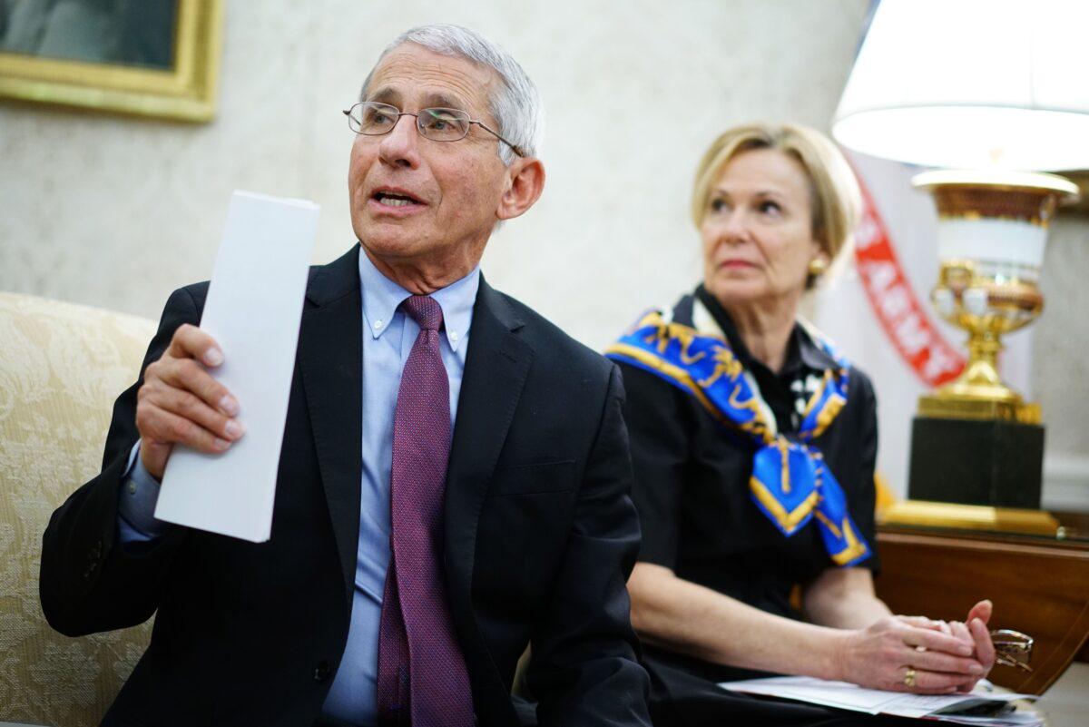 Dr. Anthony Fauci, left, director of the National Institute of Allergy and Infectious Diseases, speaks next to response coordinator for the White House coronavirus task force Dr. Deborah Birx, during a meeting in the Oval Office of the White House on April 29, 2020. (Mandel Ngan/AFP via Getty Images)