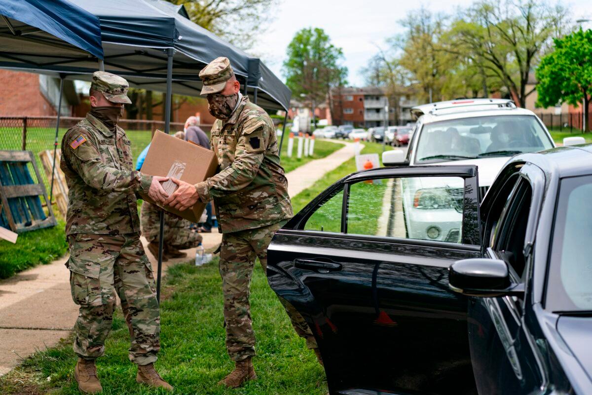 Soldiers with the Maryland Army National Guard distribute food to those in need in Windsor Mill, Md., during the COVID-19 pandemic, on May 2, 2020. (Alex Edelman/AFP via Getty Images)