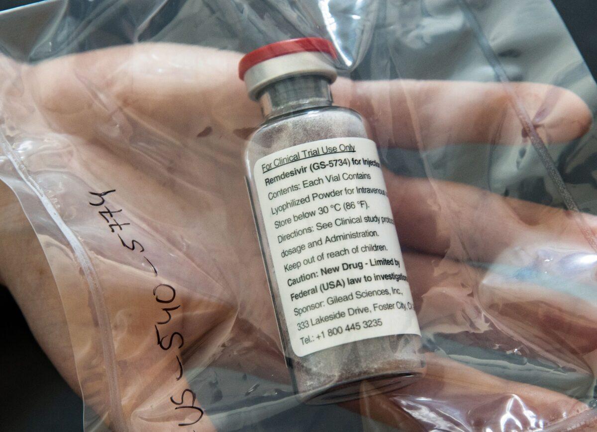 A vial of the drug Remdesivir held by a researcher at a facility in Hamburg, Germany, on April 8, 2020. (Ulrich Perey/Pool/AFP via Getty Images)