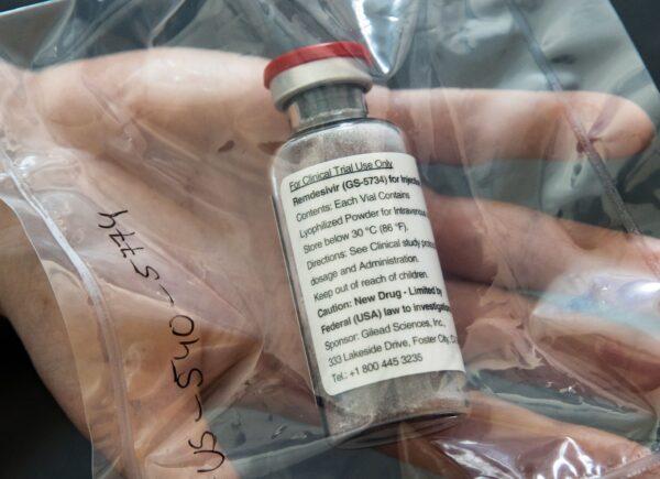 A vial of the drug remdesivir held by a researcher at a facility in Hamburg, Germany, on April 8, 2020. (Ulrich Perey/Pool/AFP via Getty Images)