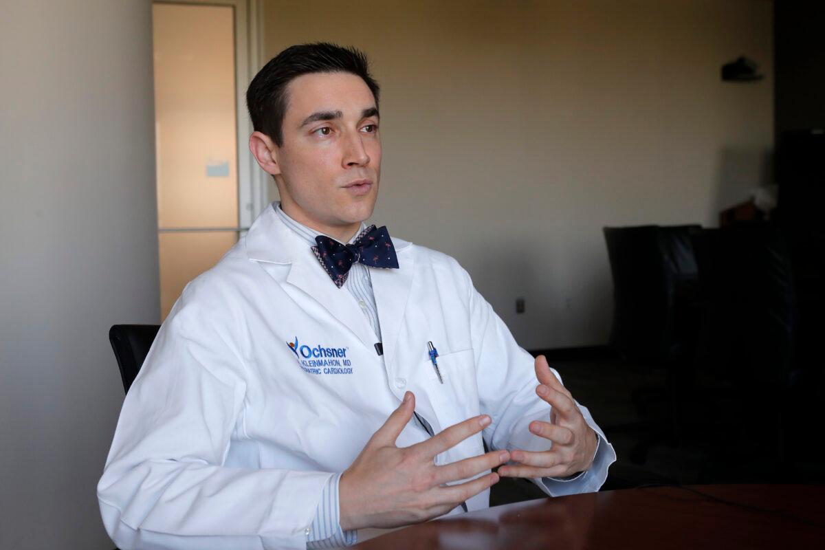 Jake Kleinmahon, a pediatric cardiologist at Ochsner Medical Center, discusses the medical care for patient Juliet Daly, 12, who almost died from the CCP virus, in Jefferson Parish, La., on April 30, 2020. (Gerald Herbert/AP Photo)