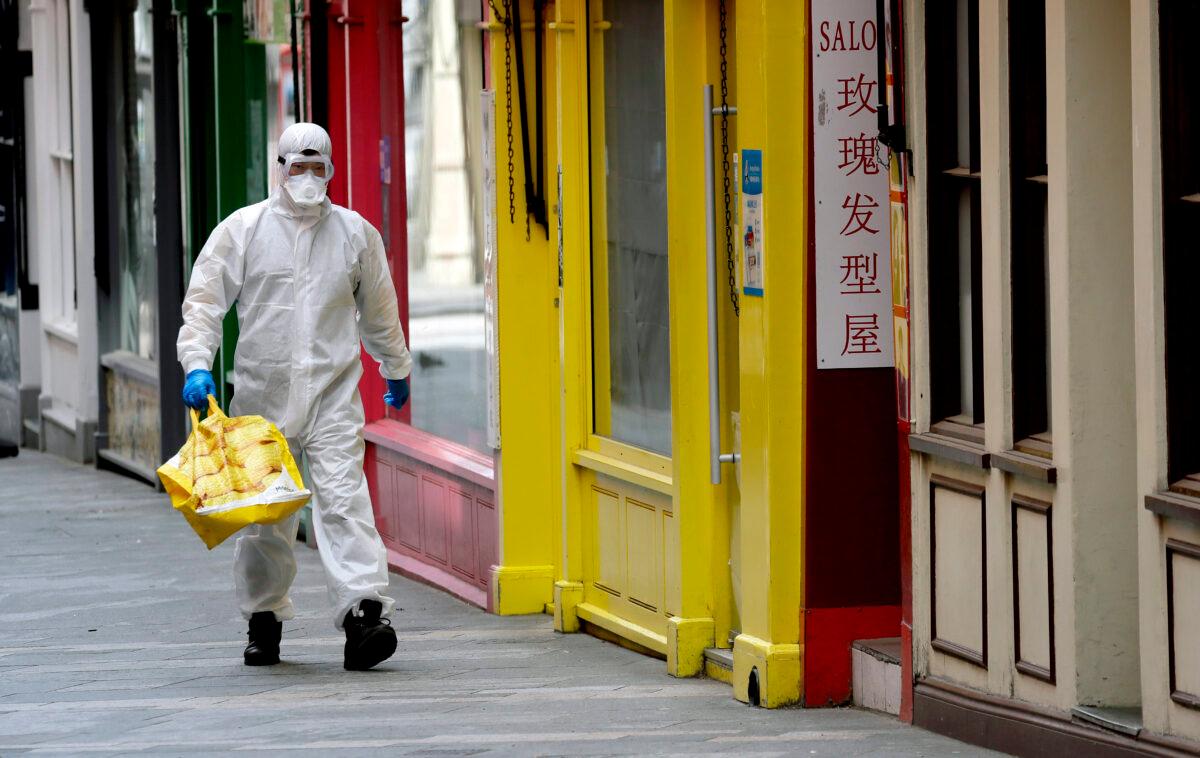 A man wears full protective equipment to protect against the CCP virus as he shops in London on May 4, 2020. (Kirsty Wigglesworth /AP Photo)