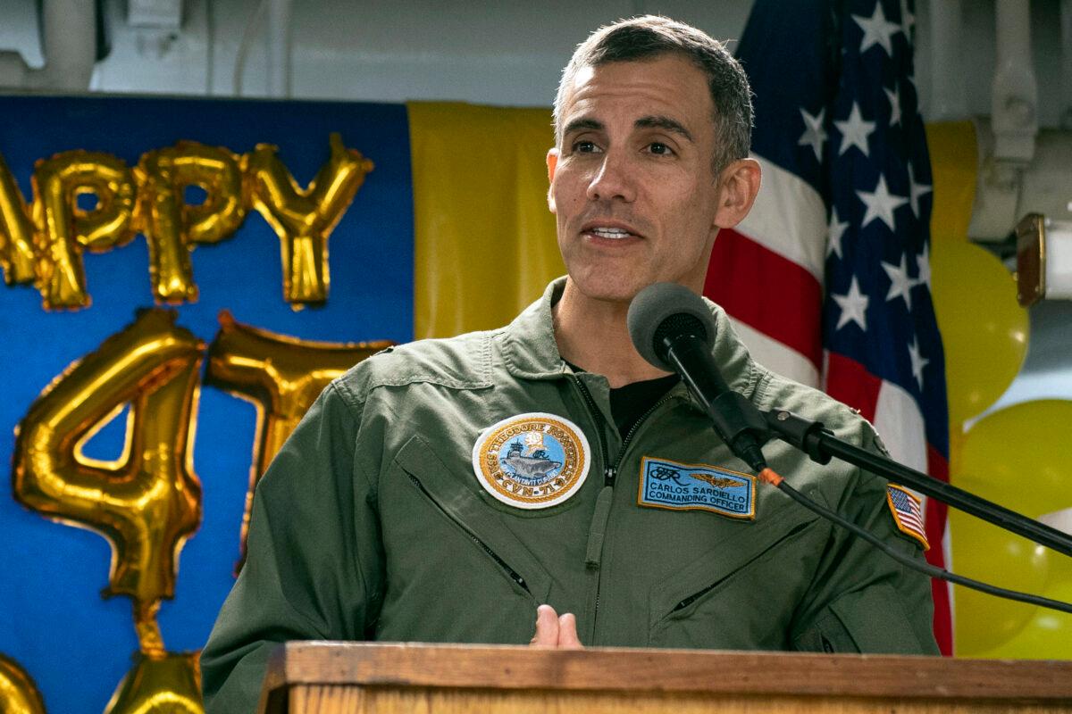 File photo of U.S. Navy, Capt. Carlos Sardiello, who was then the commanding officer of the aircraft carrier USS Theodore Roosevelt (CVN 71), addresses sailors during the 244th Navy birthday celebration on the mess decks during a home port visit in San Diego, Oct. 15, 2019. (Petty Officer 3rd Class Zachary Wheeler/U.S. Navy via AP)