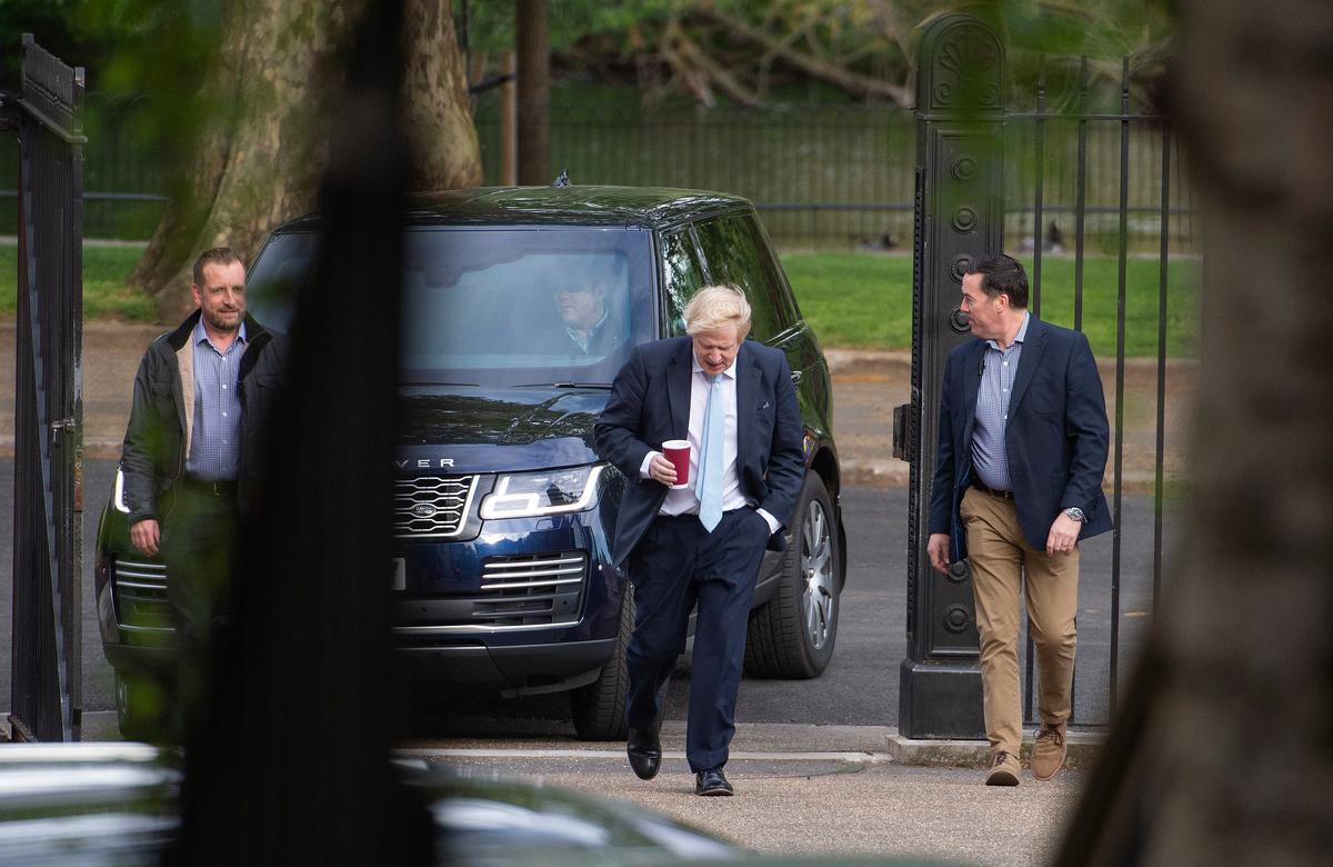 Britain's Prime Minister Boris Johnson (C), takes a morning walk in St James' Park before returning to Downing Street in London, Tuesday May 5, 2020. (Stefan Rousseau/PA/AP)
