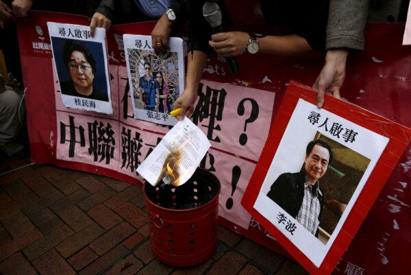 A pro-democracy demonstrator burns a letter next to pictures of missing staff members of a publishing house and a bookstore, including Gui Minhai, a China-born Swedish national who is the owner of Mighty Current, Cheung Jiping, the business manager of the publishing house and Causeway Bay Books shareholder Lee Bo (L-R), during a protest to call for an investigation behind their disappearance, outside the Chinese liaison office in Hong Kong, China, on Jan. 3, 2016. (Tyrone Siu/File Photo/Reuters)