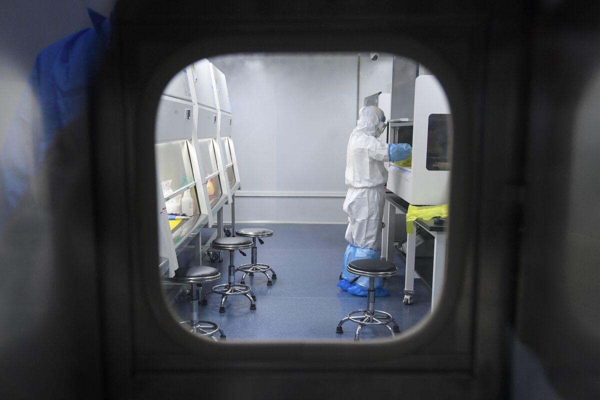 BGI Group laboratory technician working on samples from people to be tested for CCP virus at "Fire Eye" laboratory, Wuhan, Hubei China, Feb. 6, 2020. (STR/AFP via Getty Images)