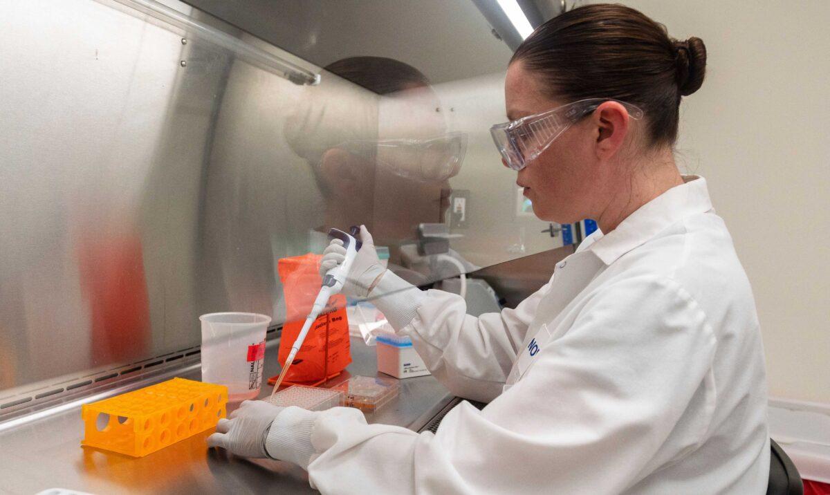A doctor looks at protein samples at Novavax labs in Rockville, Md., on March 20, 2020, one of the labs developing a vaccine for the virus that causes COVID-19. (Andrew Caballero-Reynolds/AFP/Getty Images)