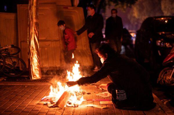 Residents burn paper offerings during the annual Tomb-Sweeping festival, also known as Qingming festival, in Wuhan, China on April 4, 2020. (NOEL CELIS/AFP via Getty Images)